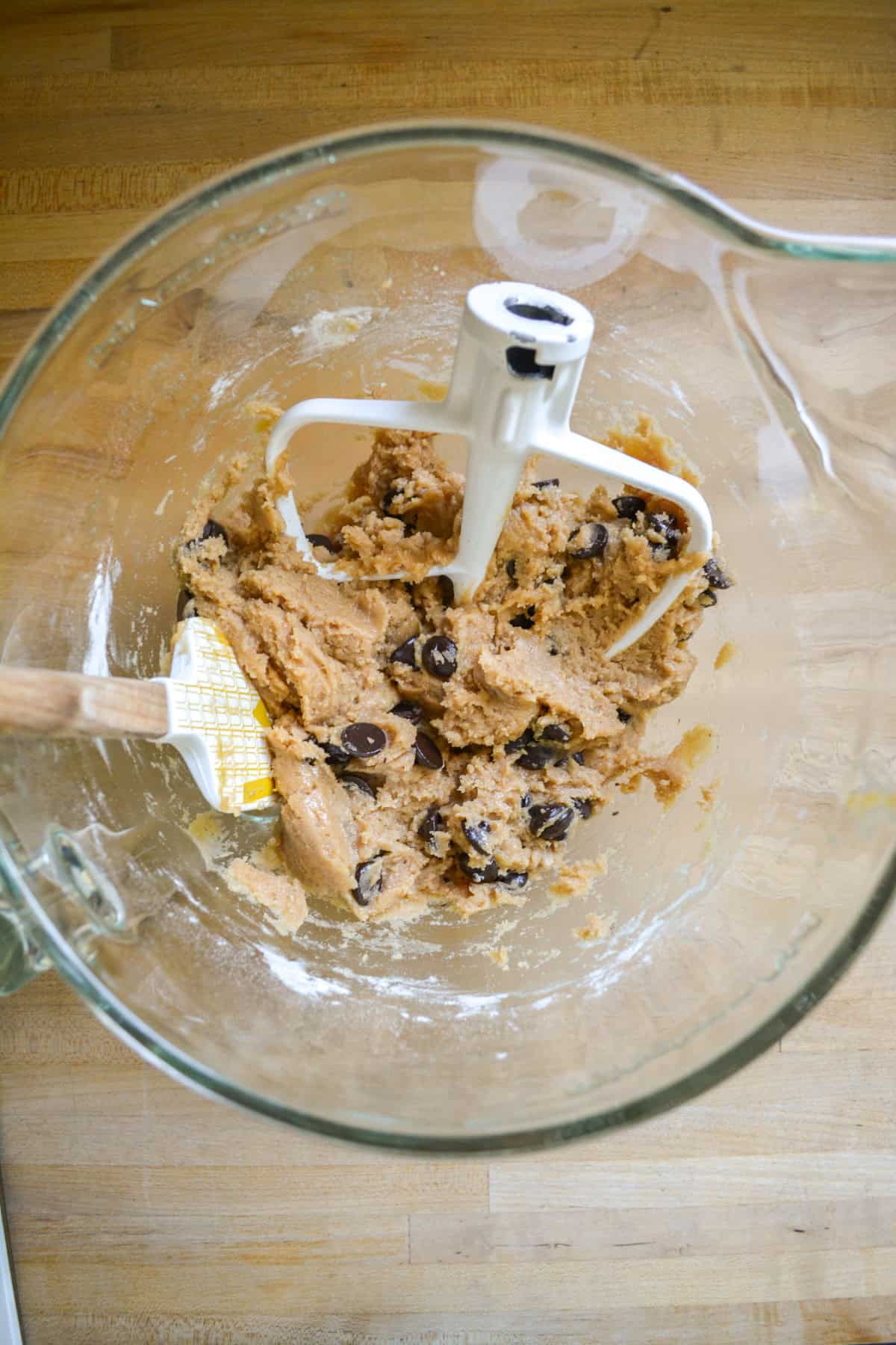 Vegan banana chocolate chip cookie dough in a glass mixing bowl.