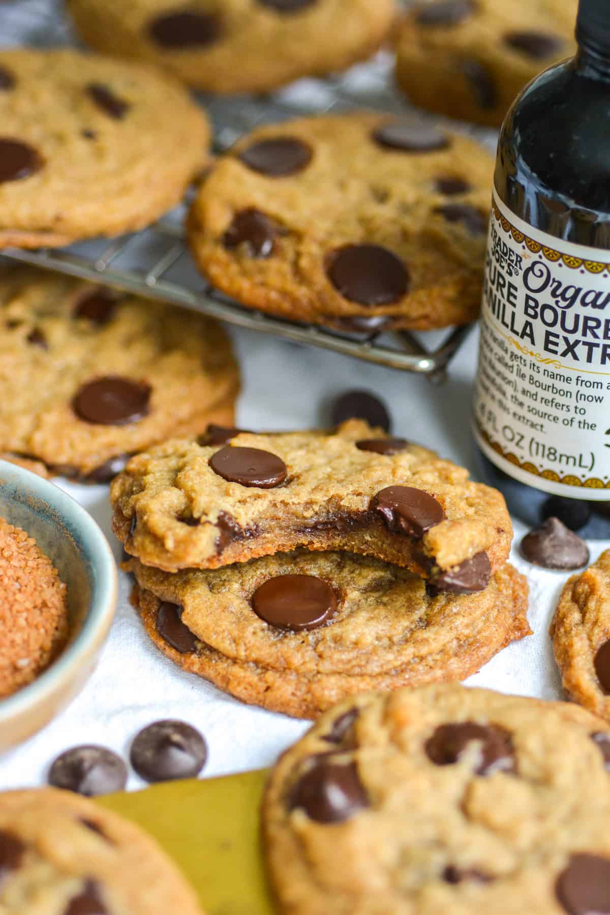 A Vegan Banana Chocolate Chip Cookie with a bite taken out of it on top of another cookie.