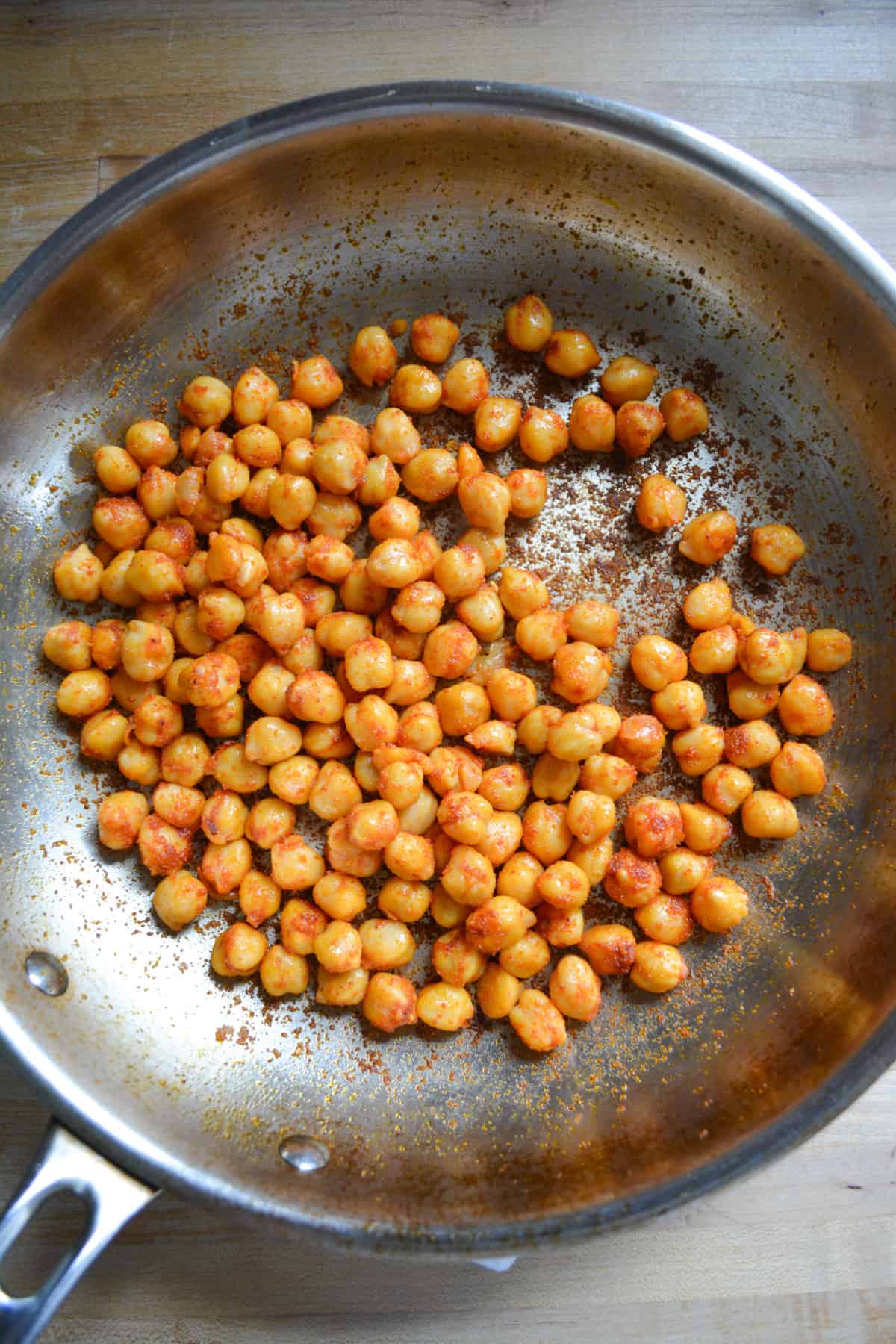 Chickpeas cooked with spices in a skillet.