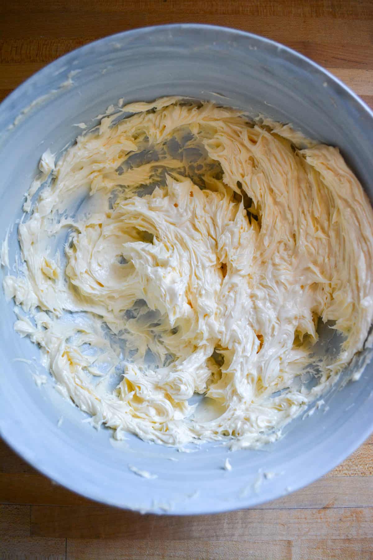 Palm oil added into the non-dairy butter and creamed together in a marble bowl.