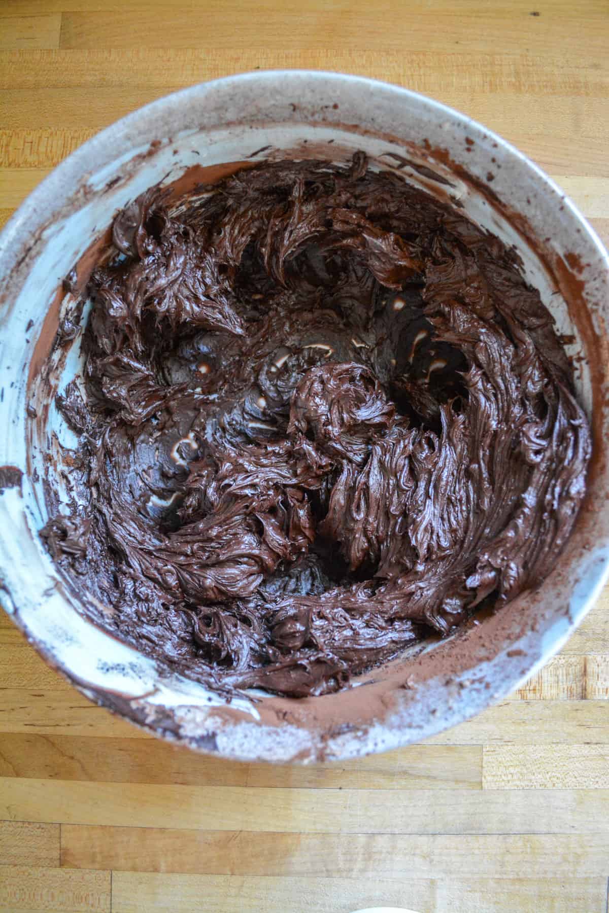 Cocoa powder mixed into the non-dairy butter in a marble bowl.