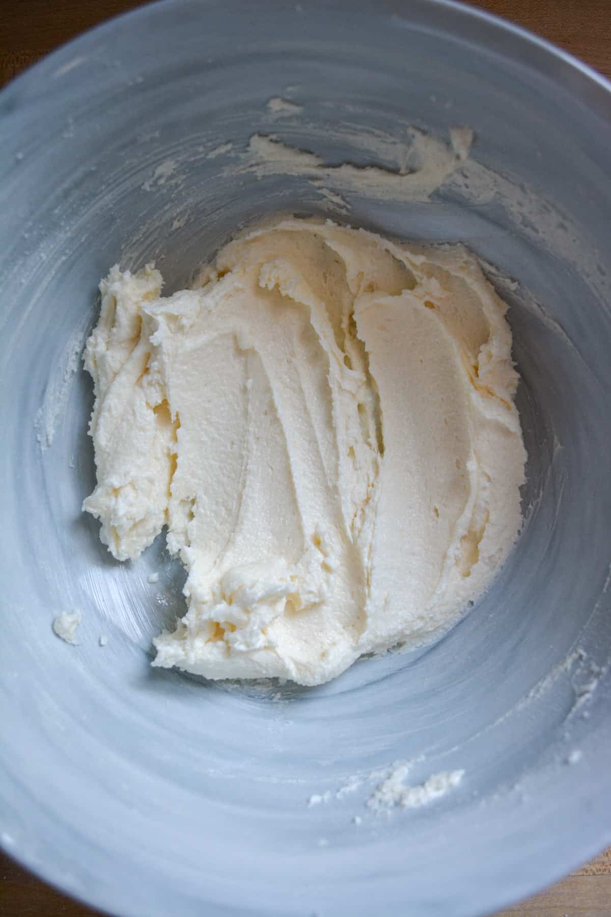 Overhead photo of vegan butter and sugar creamed together in a marble bowl.