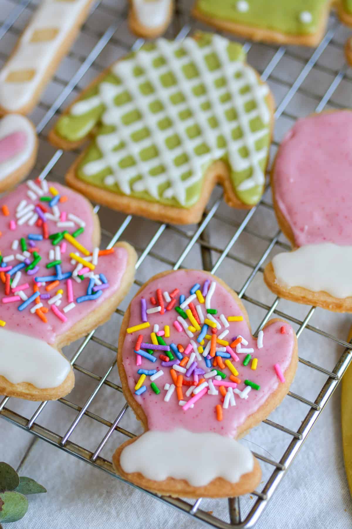Decorated vegan cut-out sugar cookies on a cooling rack.