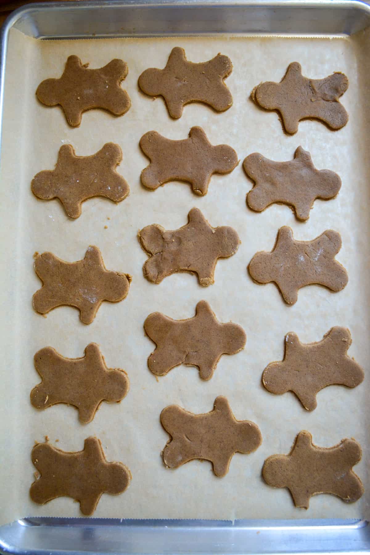 Vegan Gingerbread Cookies on a parchment lined baking sheet.