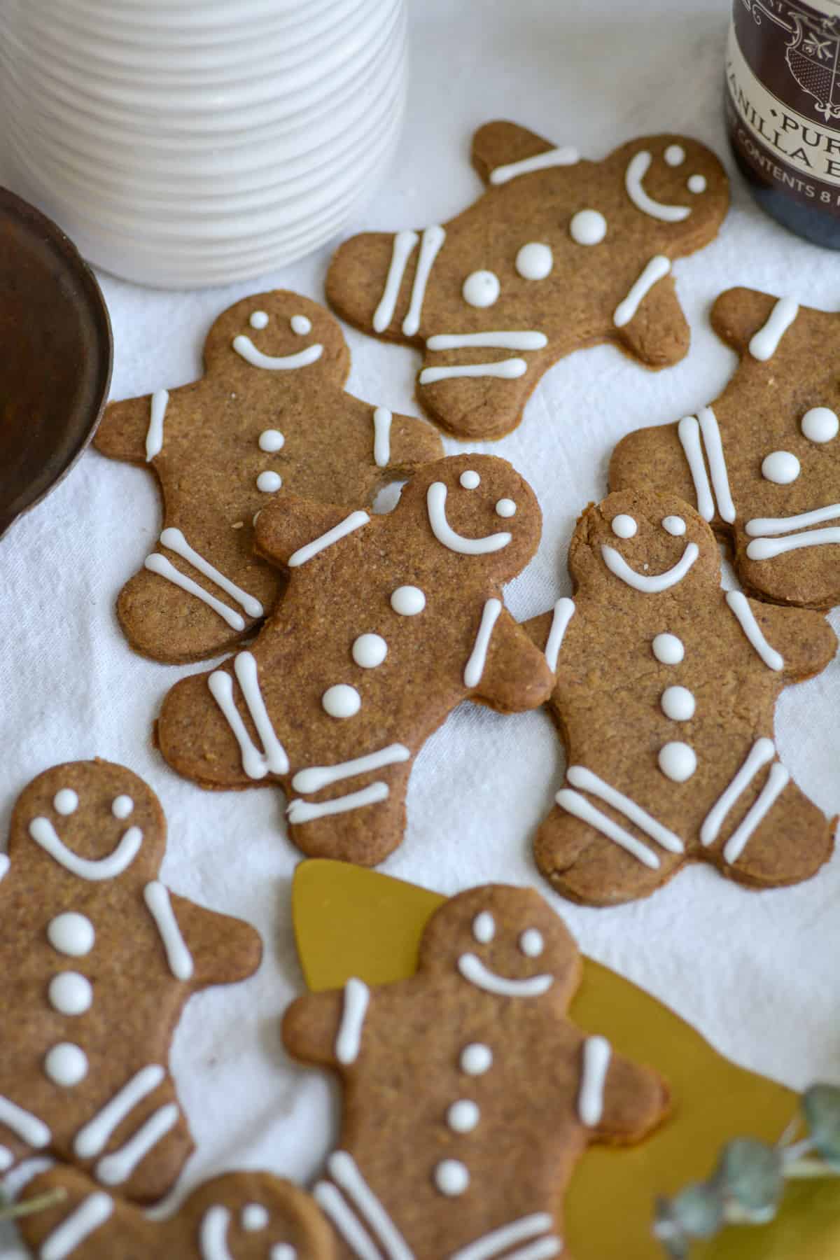Vegan Dairy-Free Gingerbread Cookies laid out on a white cloth.