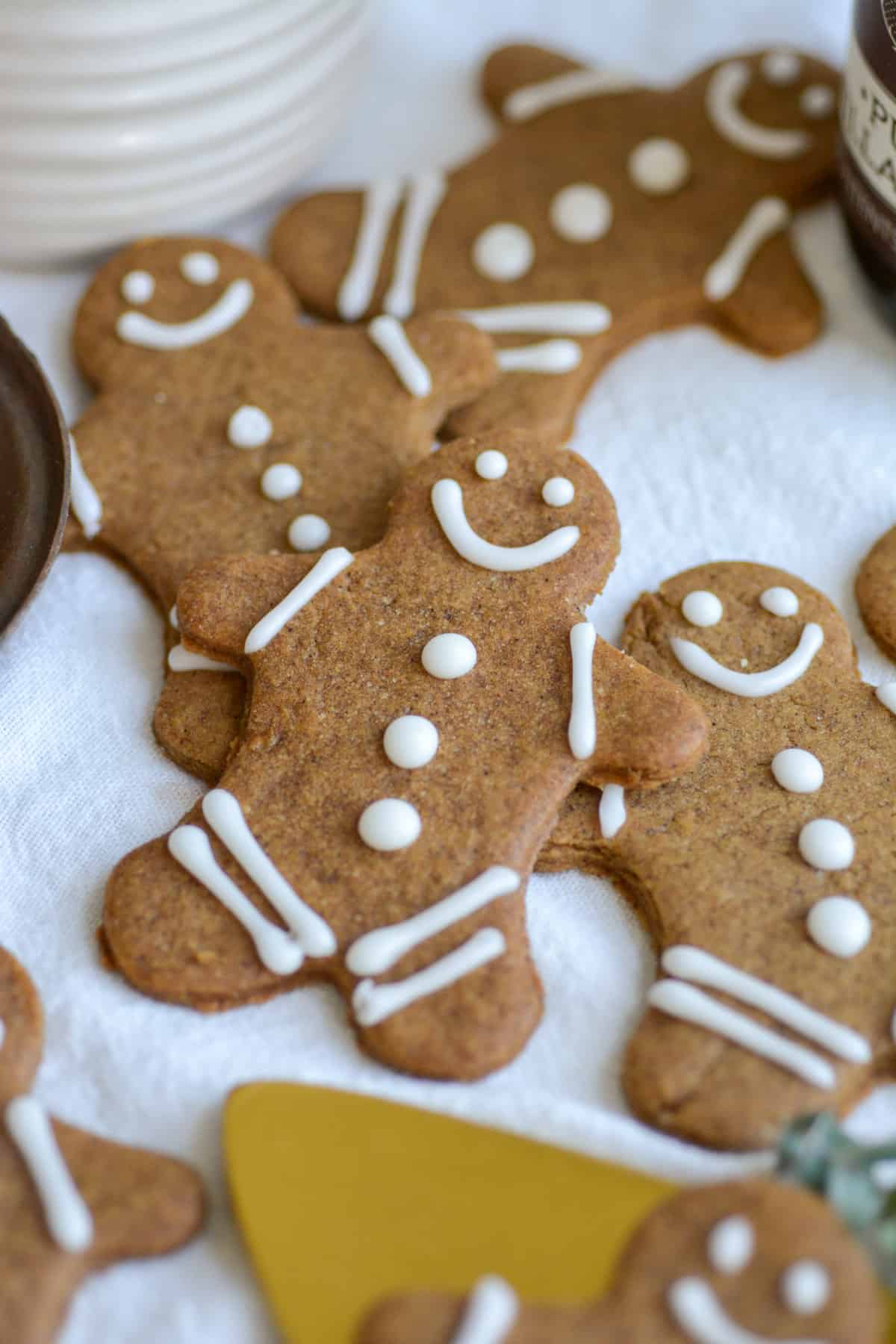 Decorated Vegan Gingersnaps on a white cloth.