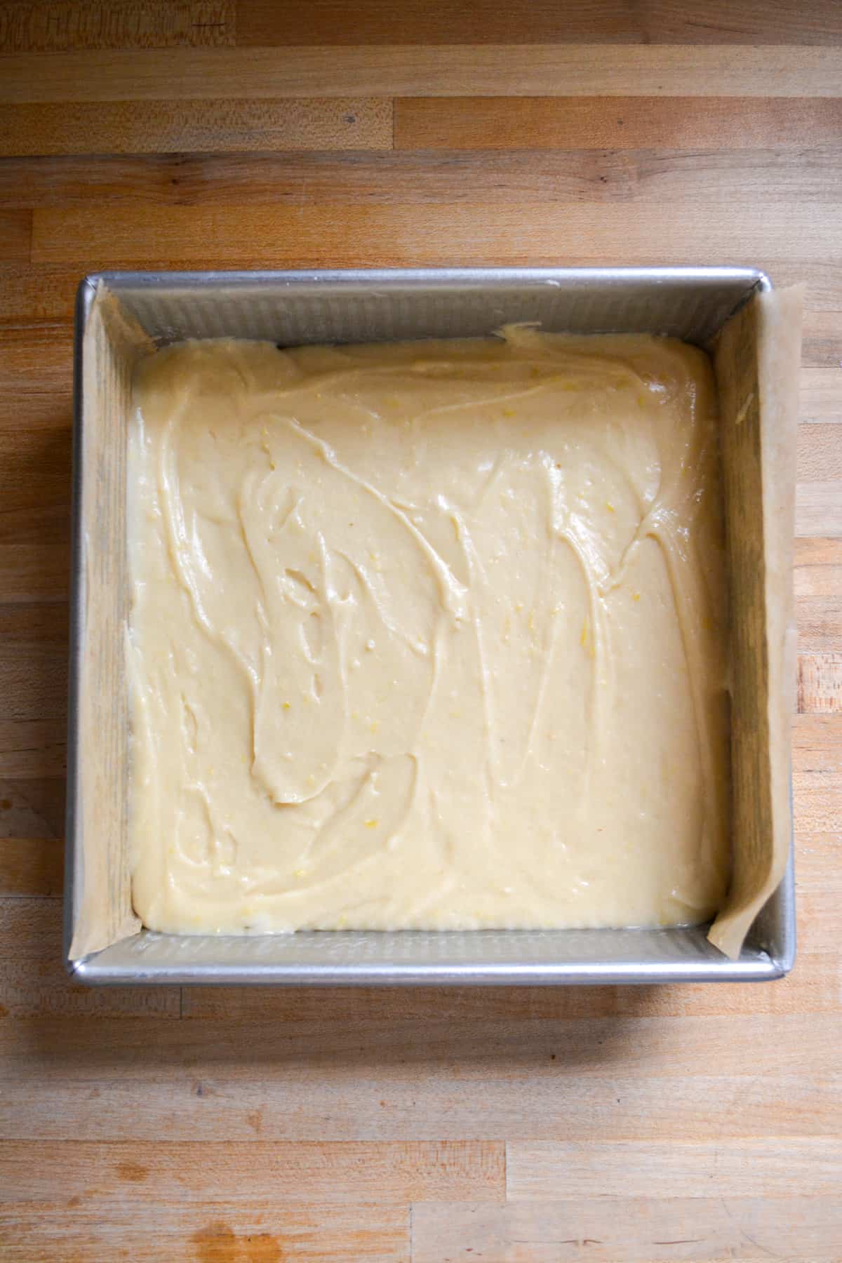 Vegan lemon cake batter in an 8 by 8 inch square pan.