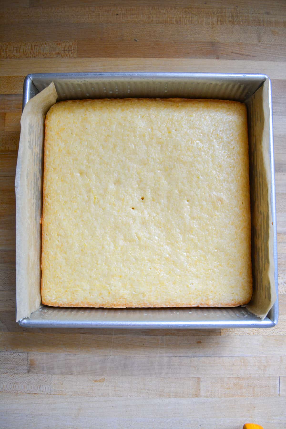 Baked Vegan Lemon Cake in an 8 by 8 inch square pan.