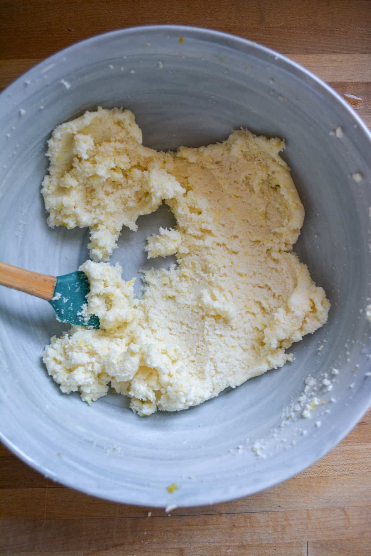 Vegan butter, sugar and lemon zest creamed together in a mixing bowl.