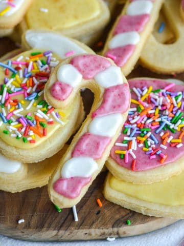 A decorated Vegan Sugar Cookie laying on top of other cookies.
