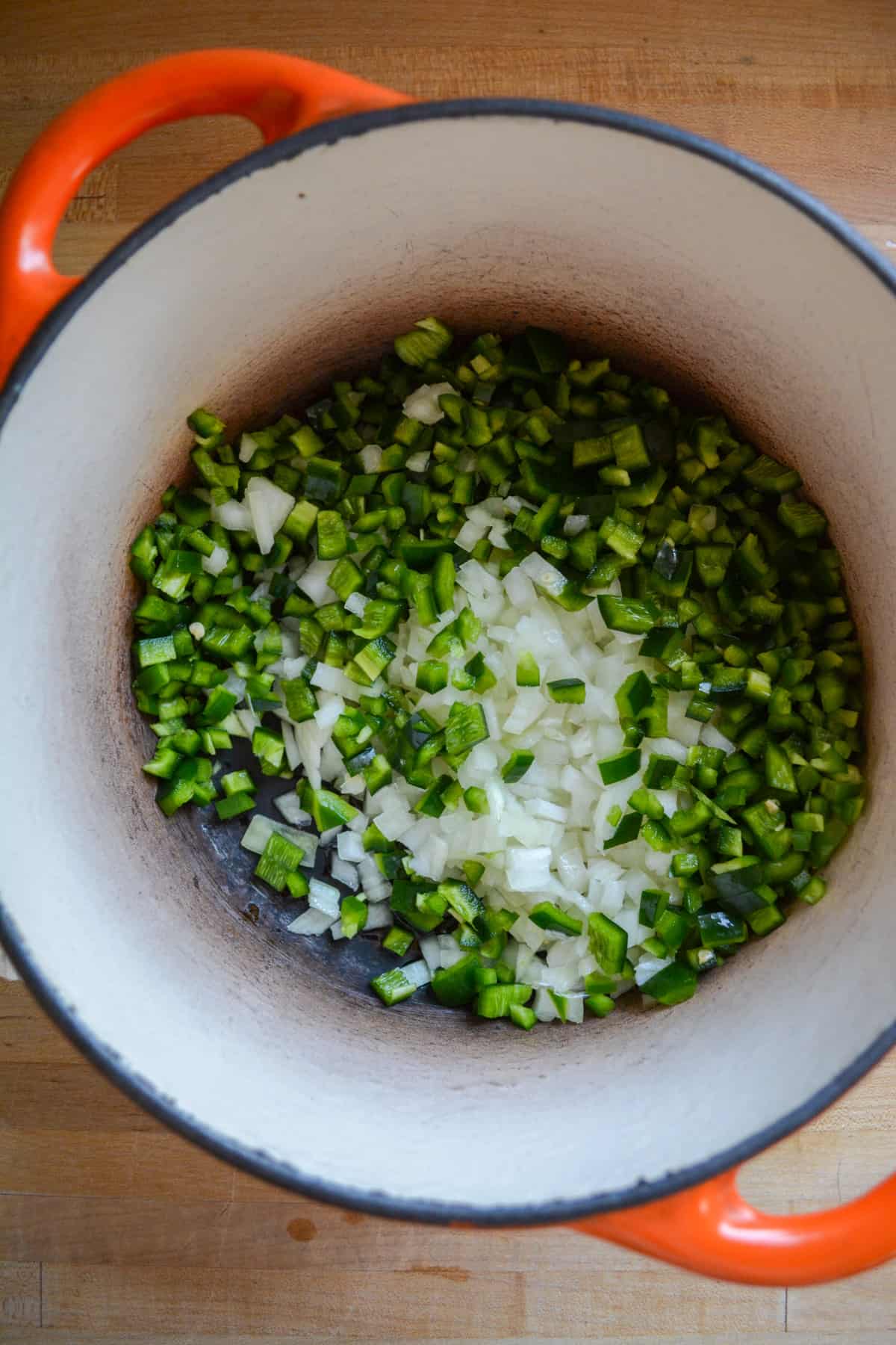 Chopped onion, poblano and jalapeno in a large dutch oven.