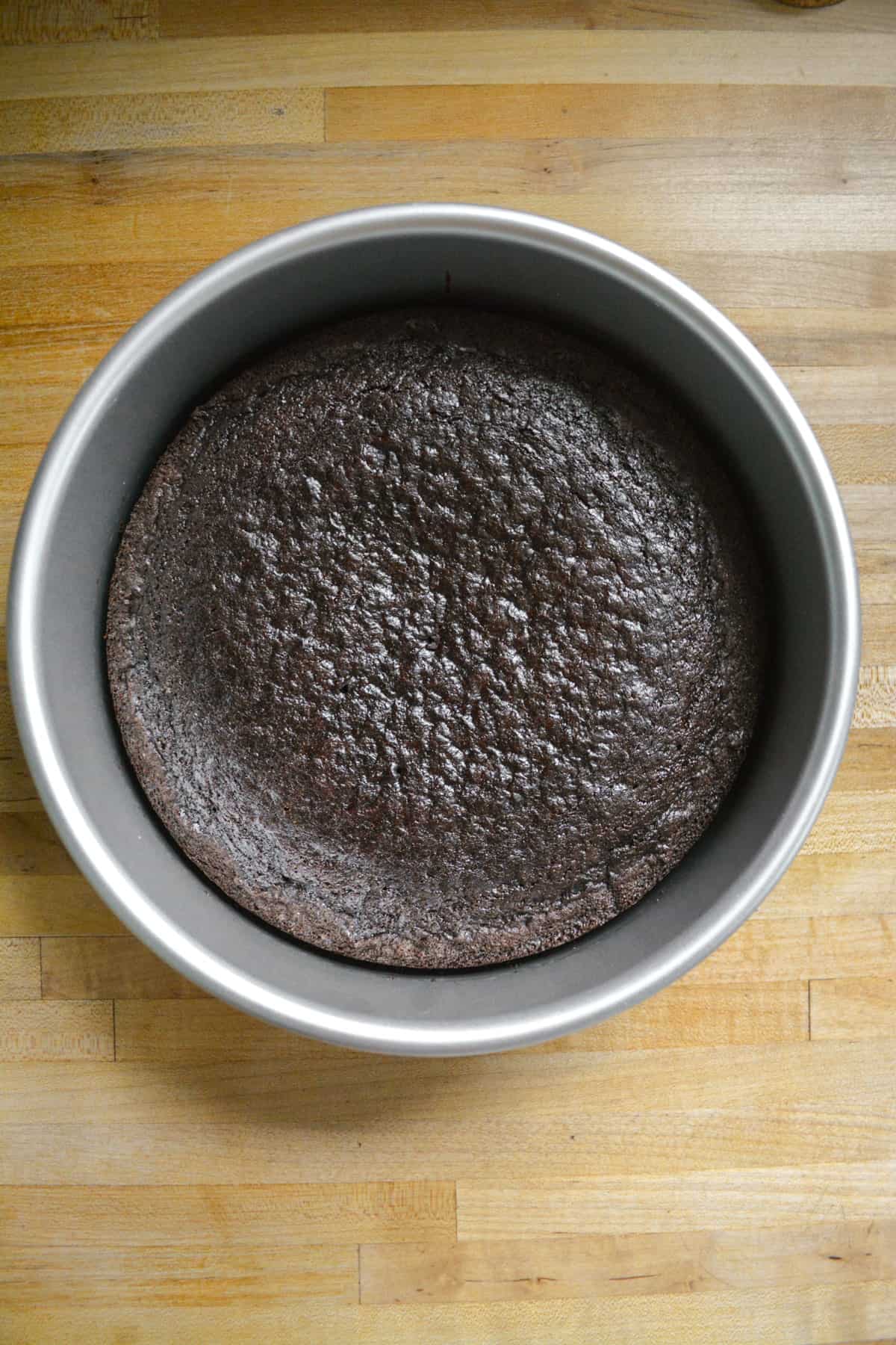 Baked single layer chocolate cake still in its pan.