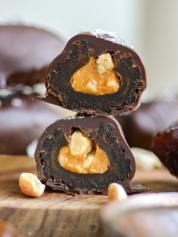 Chocolate Covered Dates with Peanut butter cut in half to show the inside.