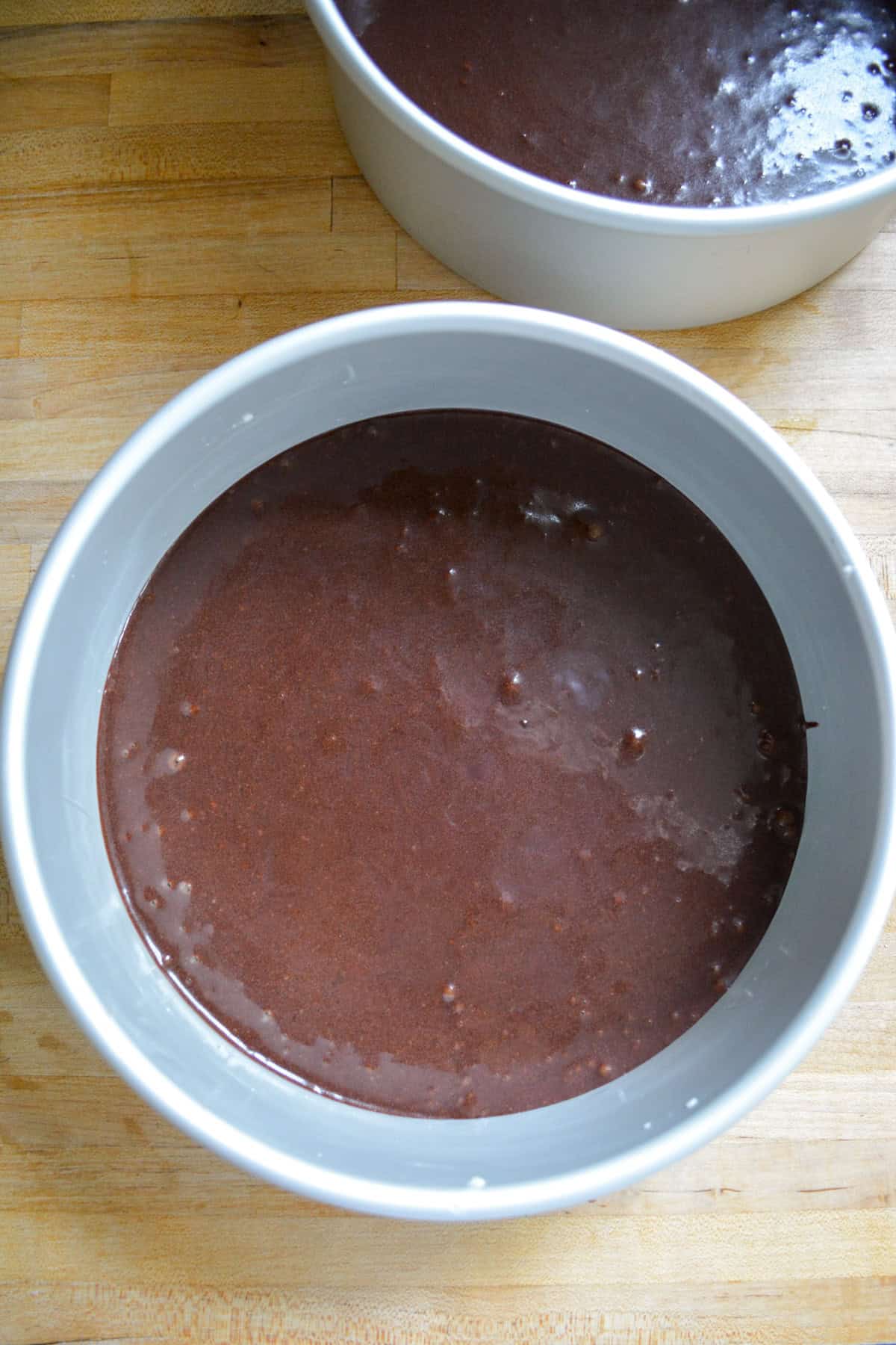 Cake batter in cake two pans.