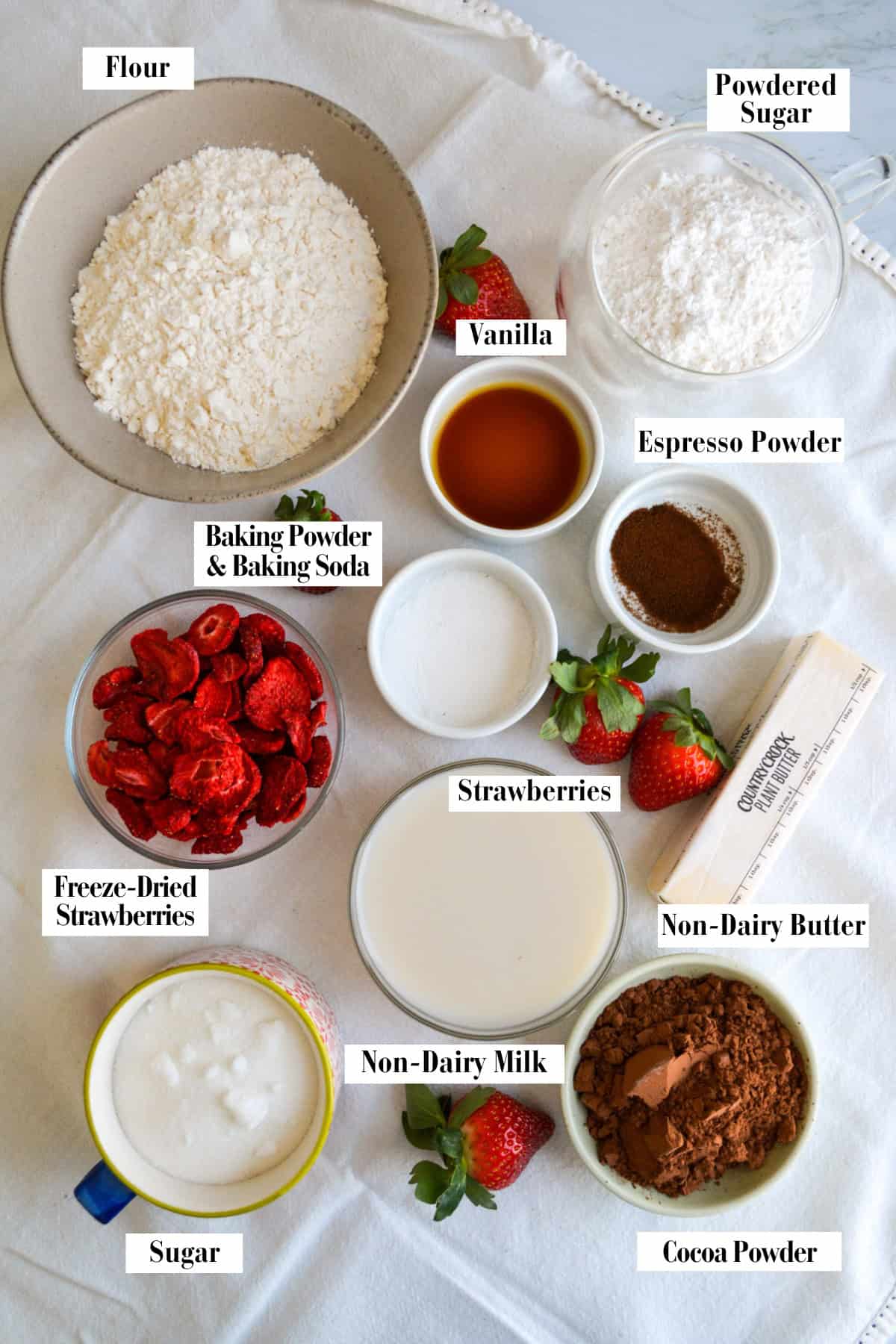 Ingredients for making this recipe in small bowls on a linen surface.