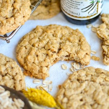 A Peanut Butter Oatmeal Cookie with a bite taken out of it on a linen cloth.