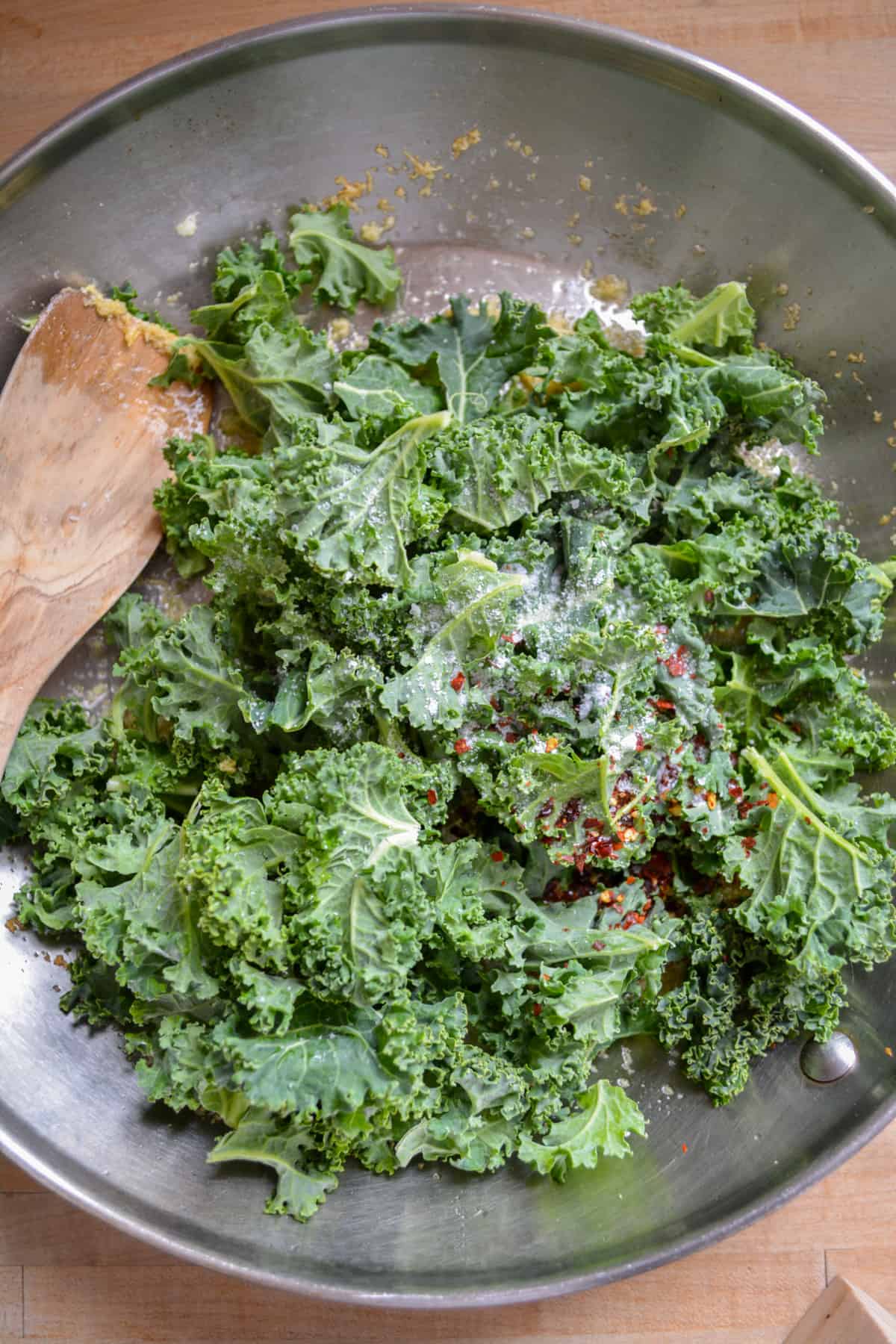 Kale, red pepper flake and salt added into the skillet.