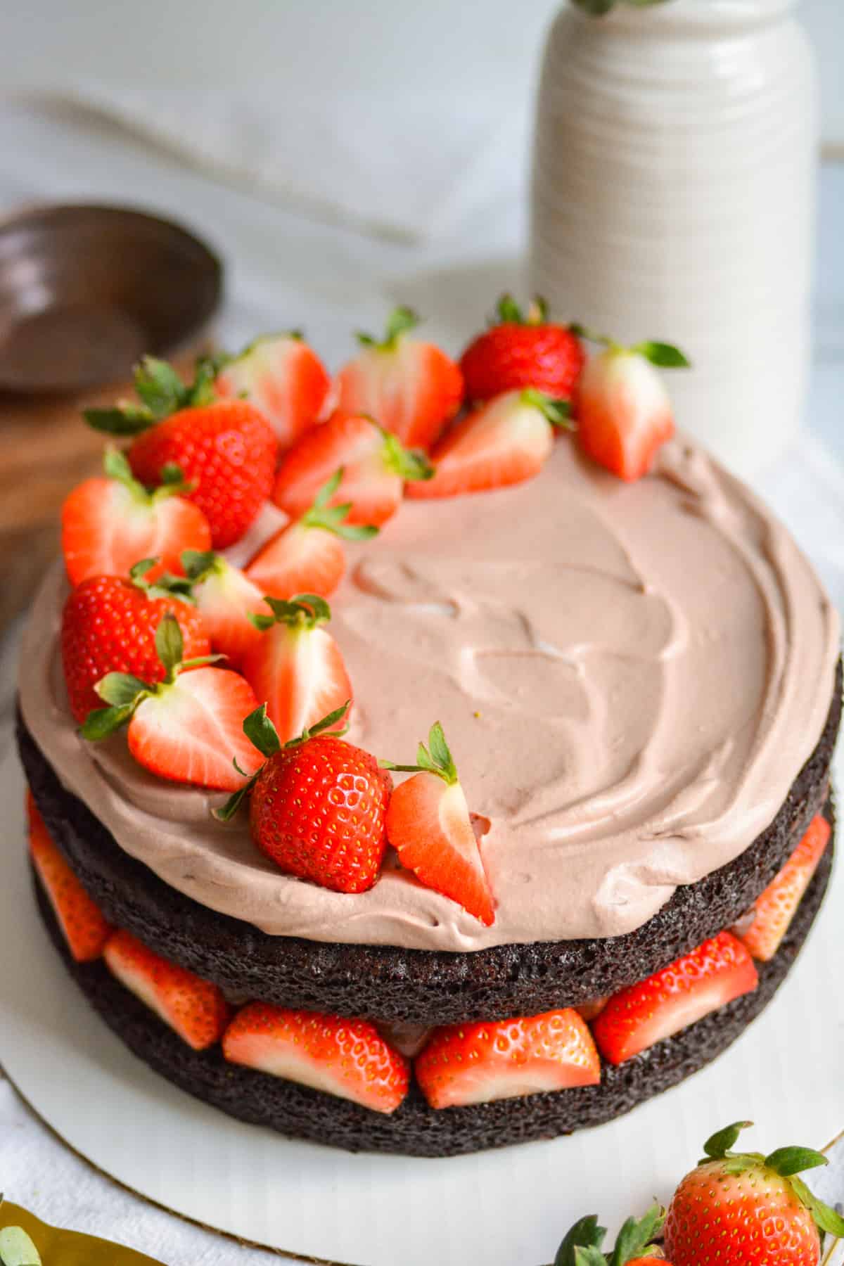 Chocolate whipped cream and strawberries added to the top of the cake.