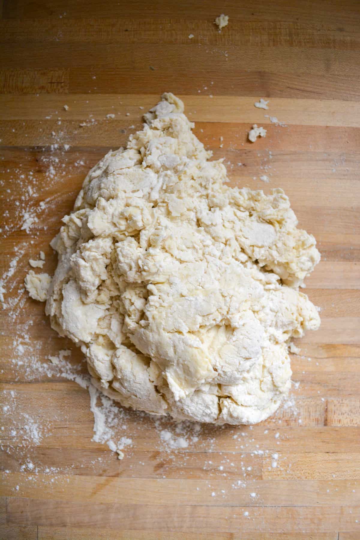 Shaggy dough on a floured wooden surface.