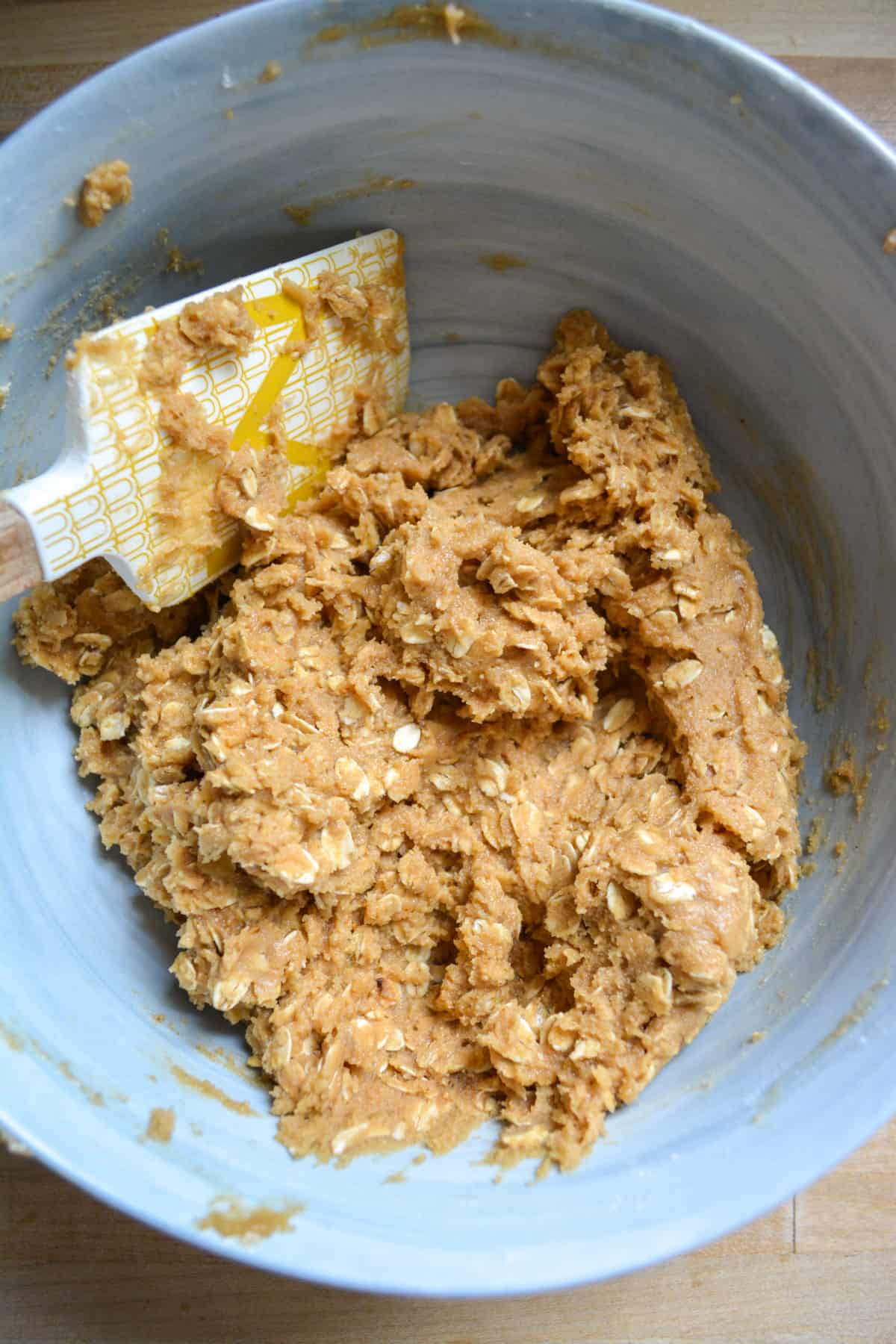 Flour and oats added into the peanut butter mixture to form the cookie dough.