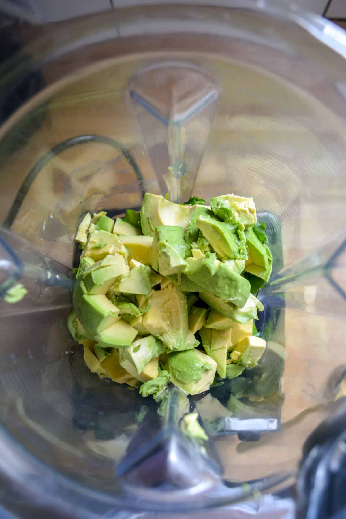 Ingredients for making avocado crema in a blender.