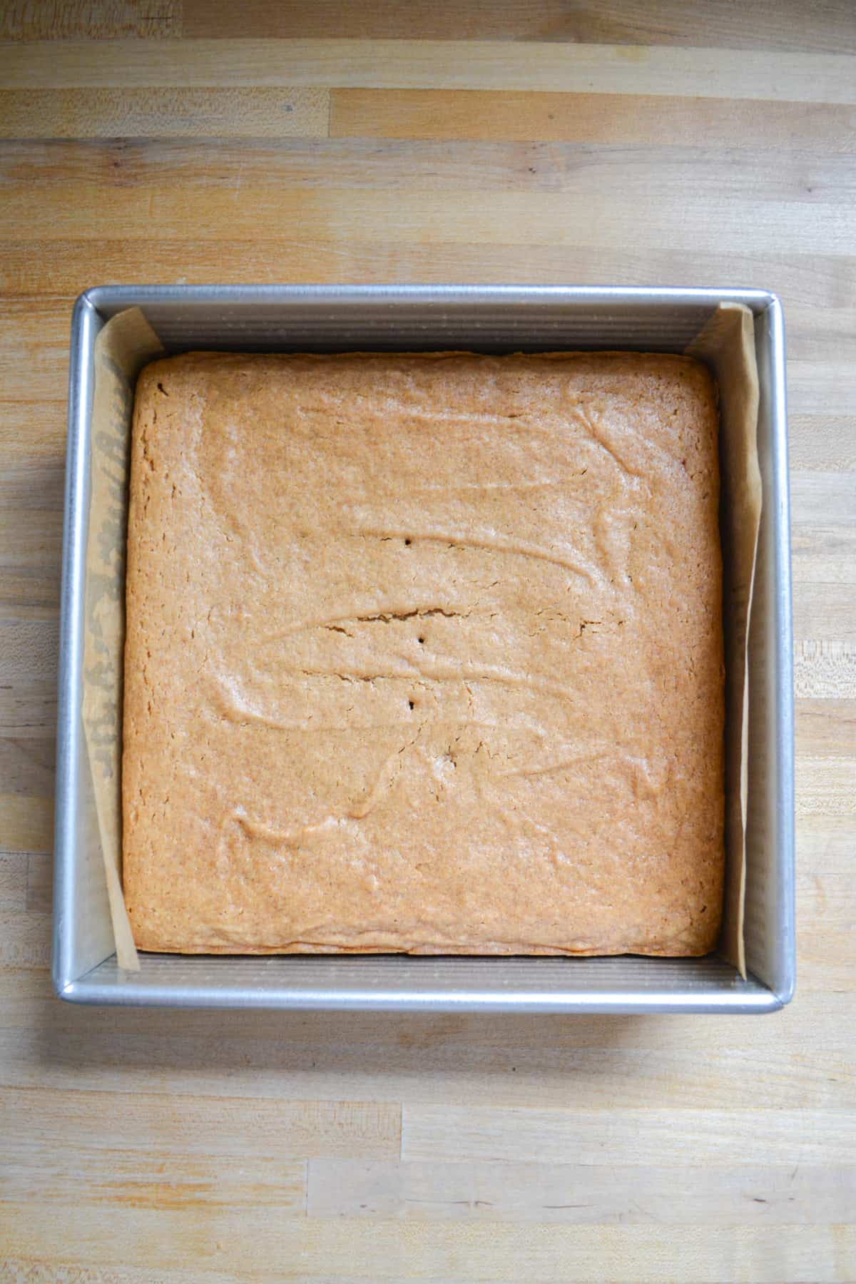 Baked cake in a square pan.
