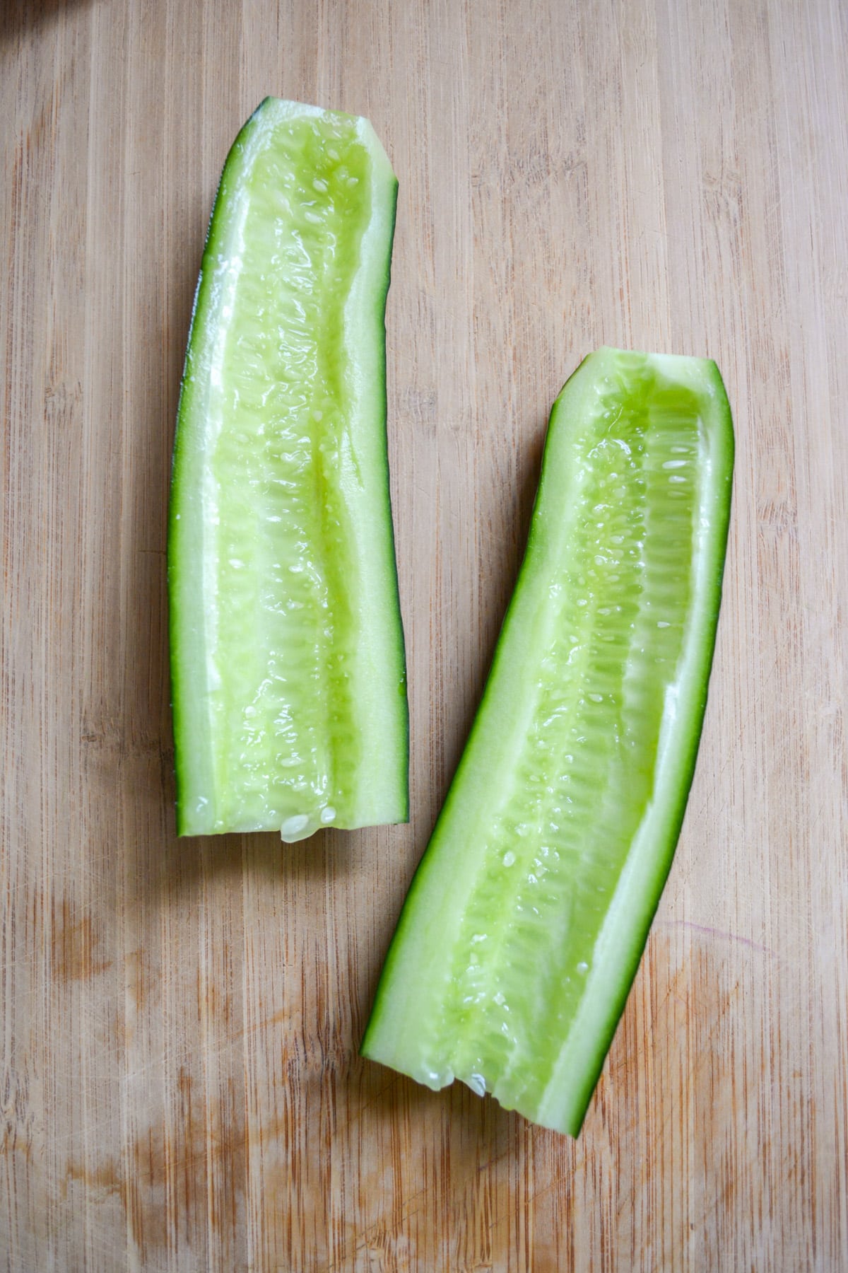 Cucumber that has beed sliced in half with the seeds removed.