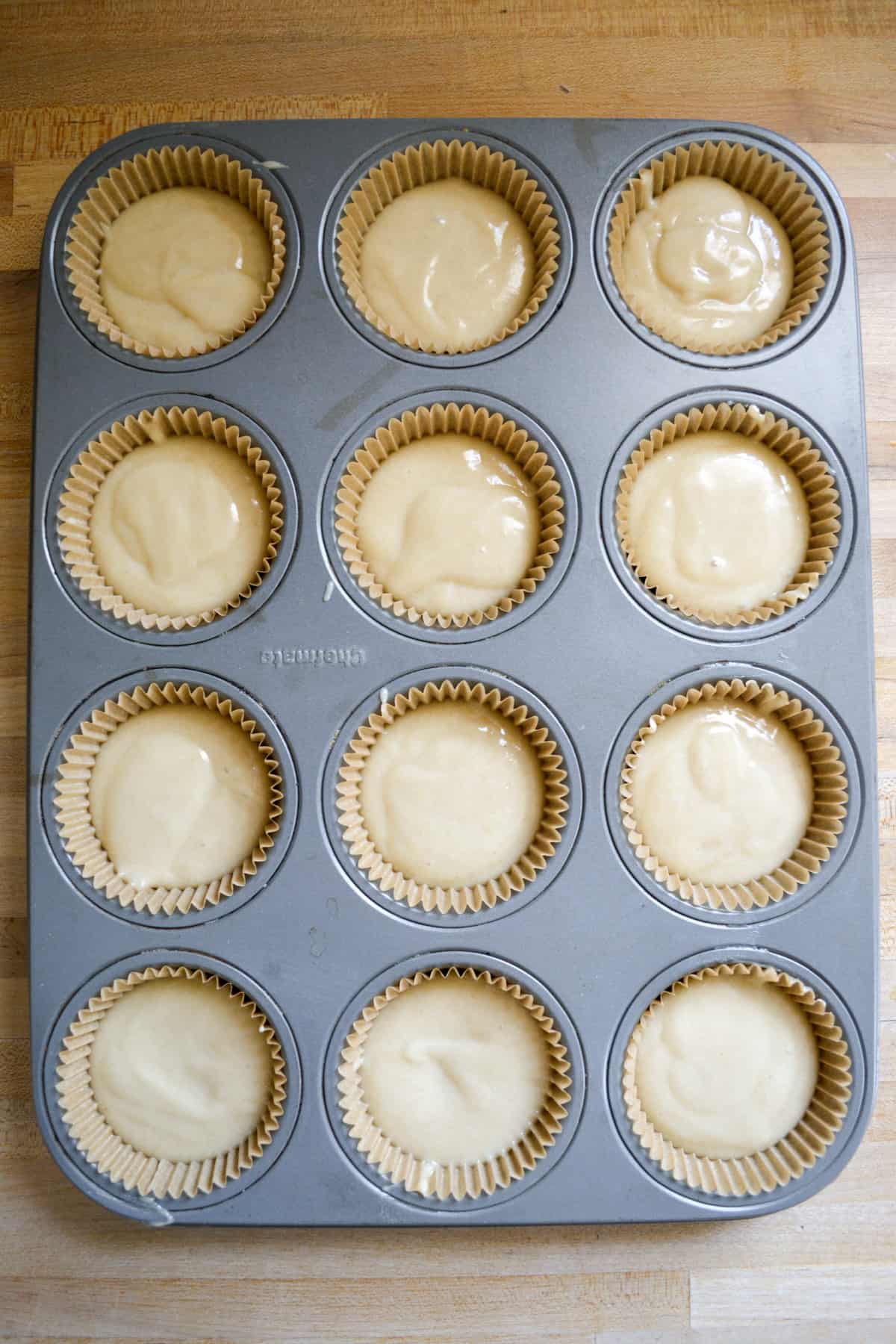 Cupcake batter portioned into a lined cupcake pan.