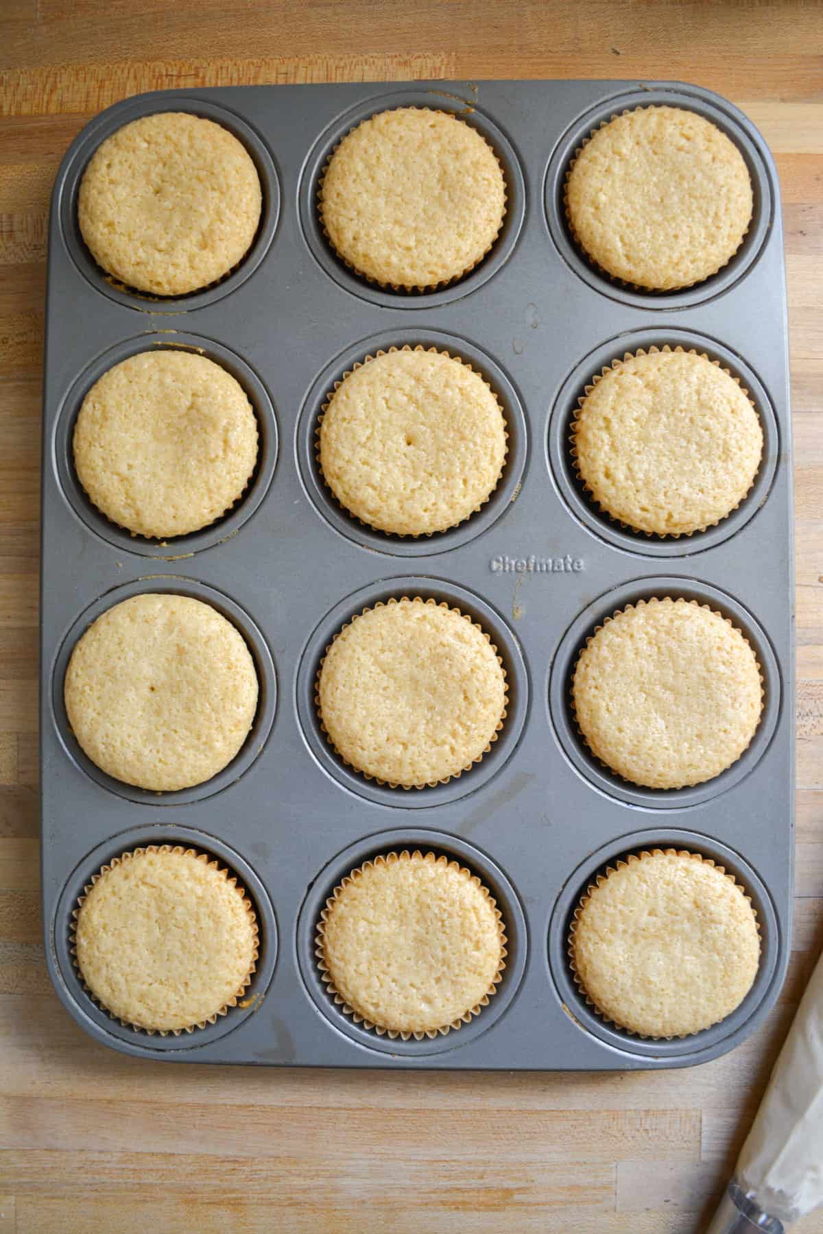 Baked lavender cupcakes in a cupcake pan.