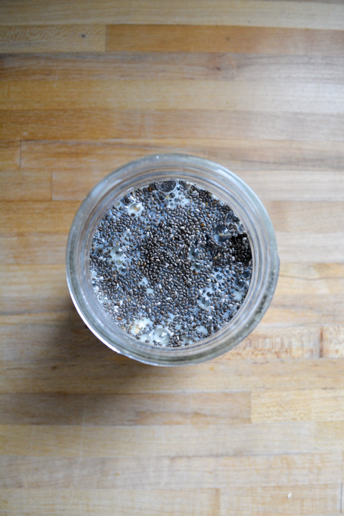 Overnight oat ingredients added to a mason jar.