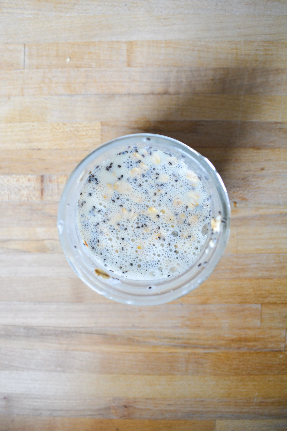The oat mixture all stirred together in a mason jar.