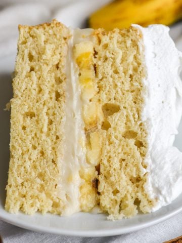 Vegan and dairy free banana cream pie cake slice on a plate.