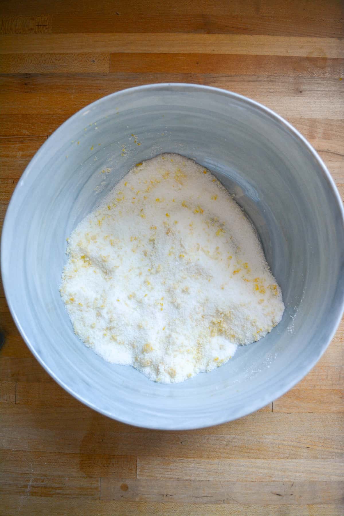 Sugar and lemon zest in a large mixing bowl.