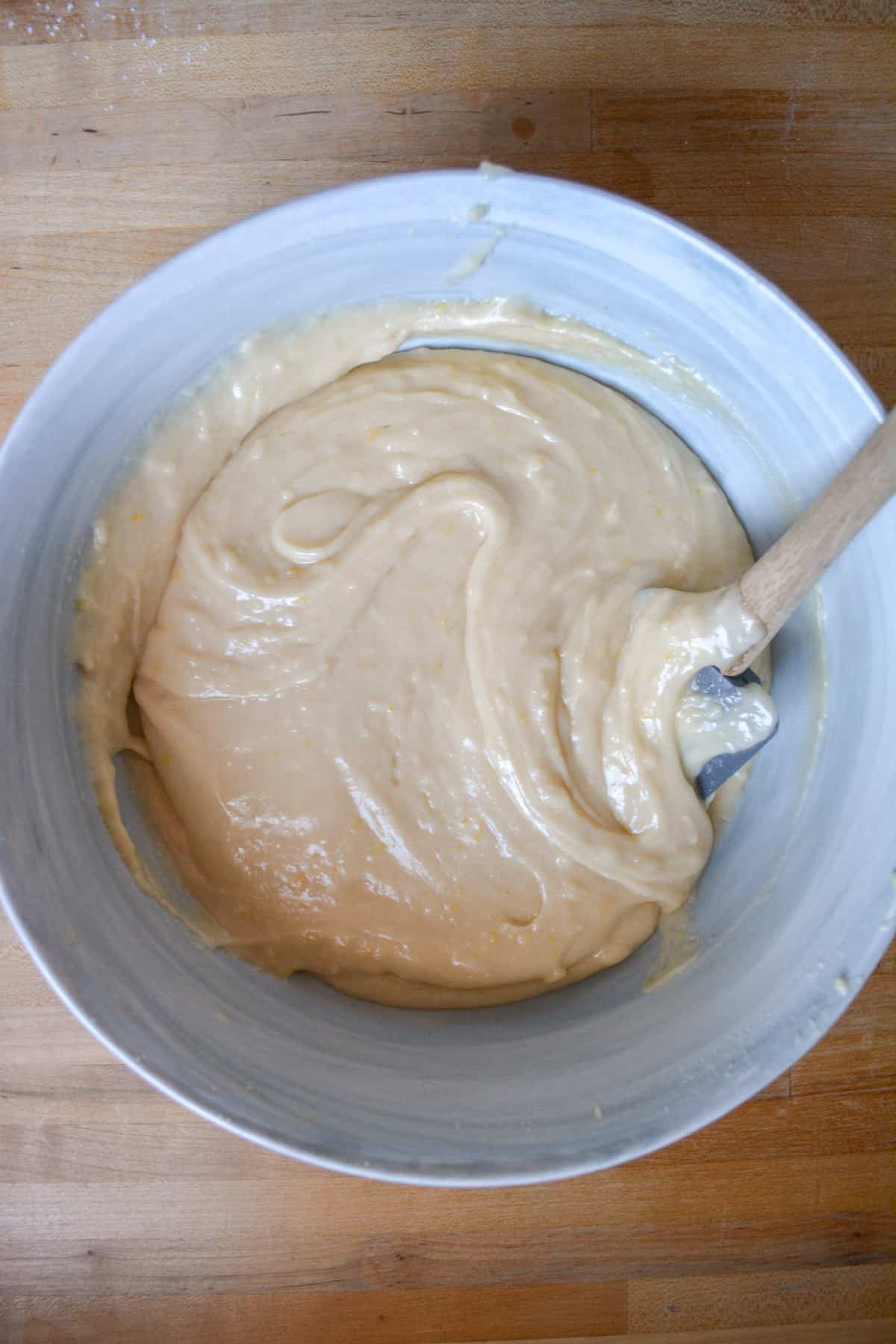Dry ingredients mixed into the bowl to form the batter with a spatula off to the right.