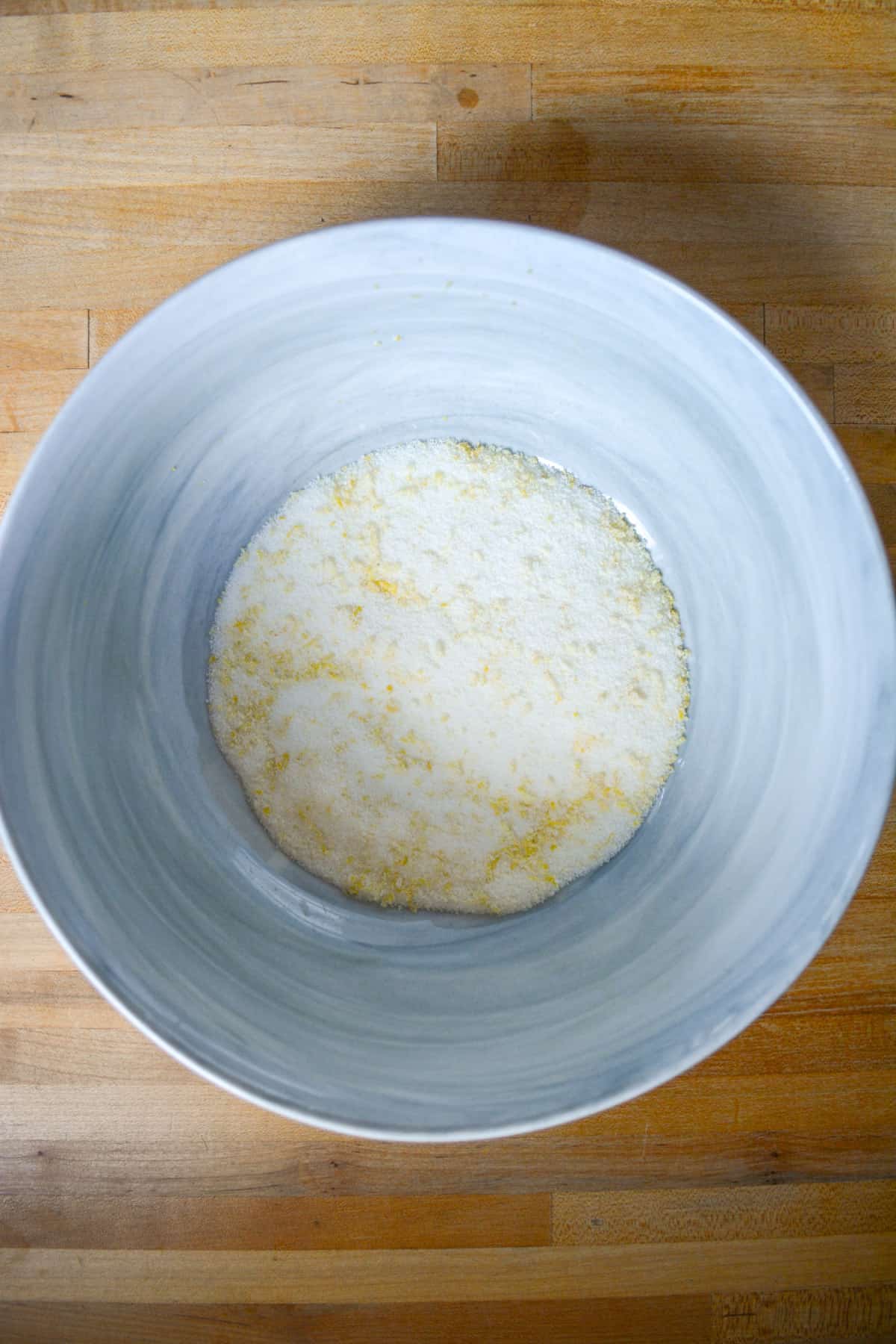 Lemon zest and sugar in a mixing bowl.