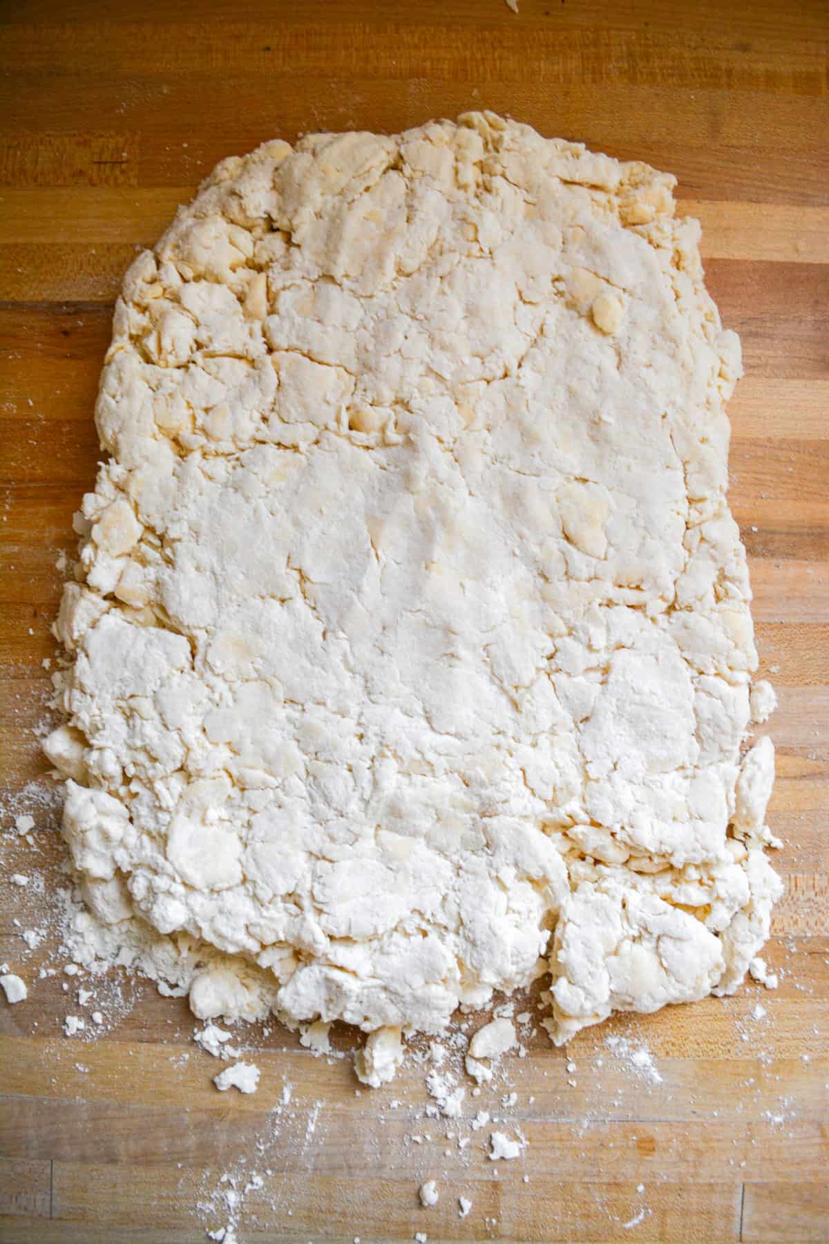 Shaggy biscuit dough pressed out into a rectangle.