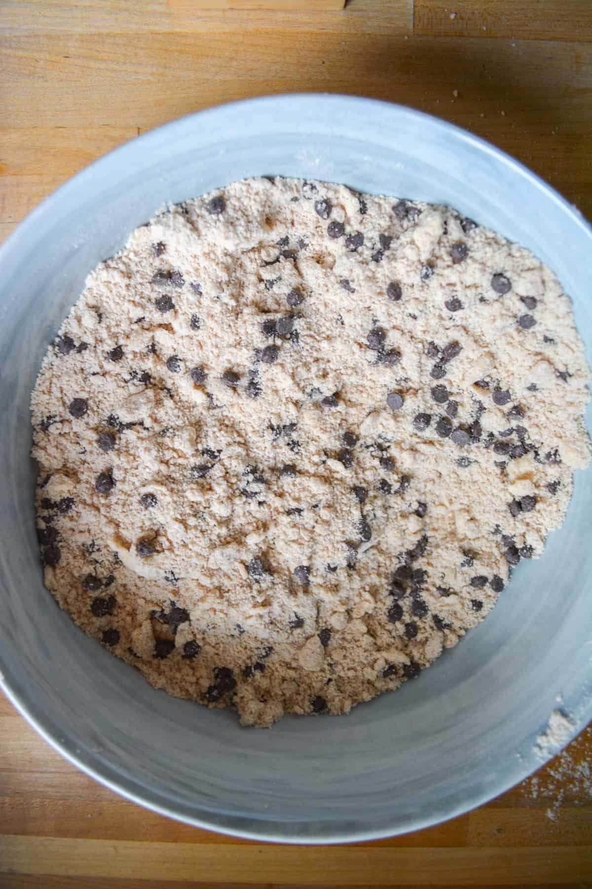 Mini chocolate chips added into the mixing bowl.
