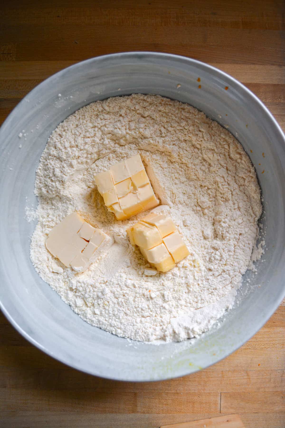 Vegan Butter added into the dry ingredients in a mixing bowl.