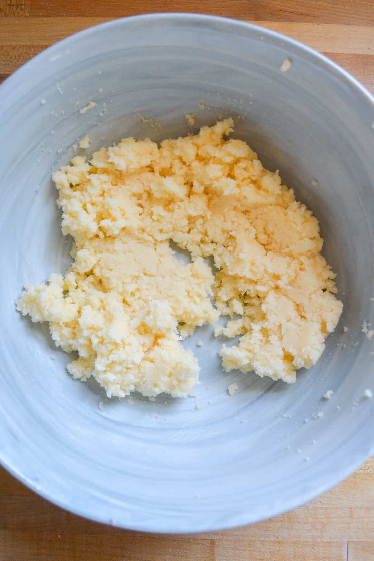 Vegan butter and sugar creamed together in a mixing bowl.