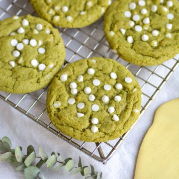 Vegan Matcha White Chocolate Chip Cookies on a wire cooling rack.