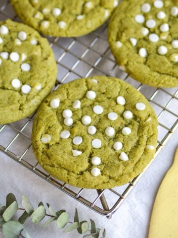 Vegan Matcha White Chocolate Chip Cookies on a wire cooling rack.