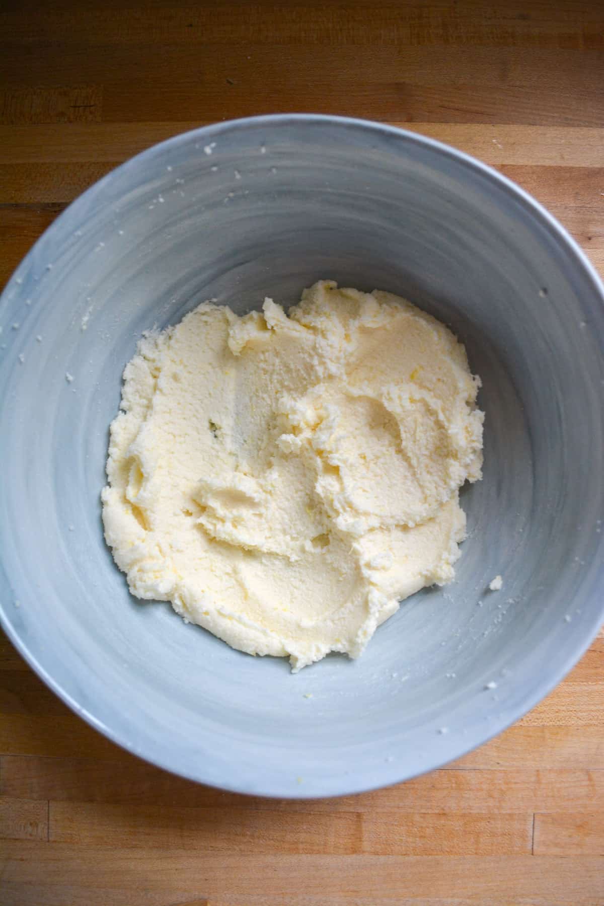 Creamed vegan butter and sugar in a mixing bowl.
