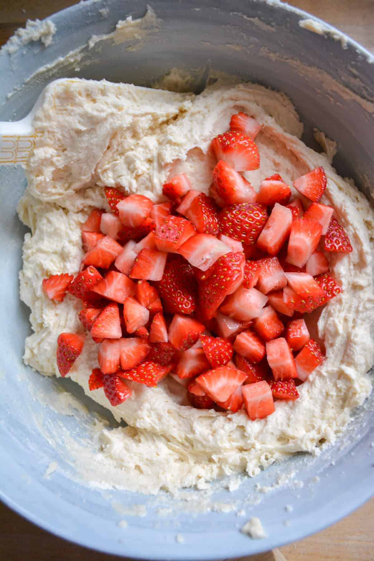 The remaining dry ingredients mixed into the pound cake batter and chopped strawberries added in.