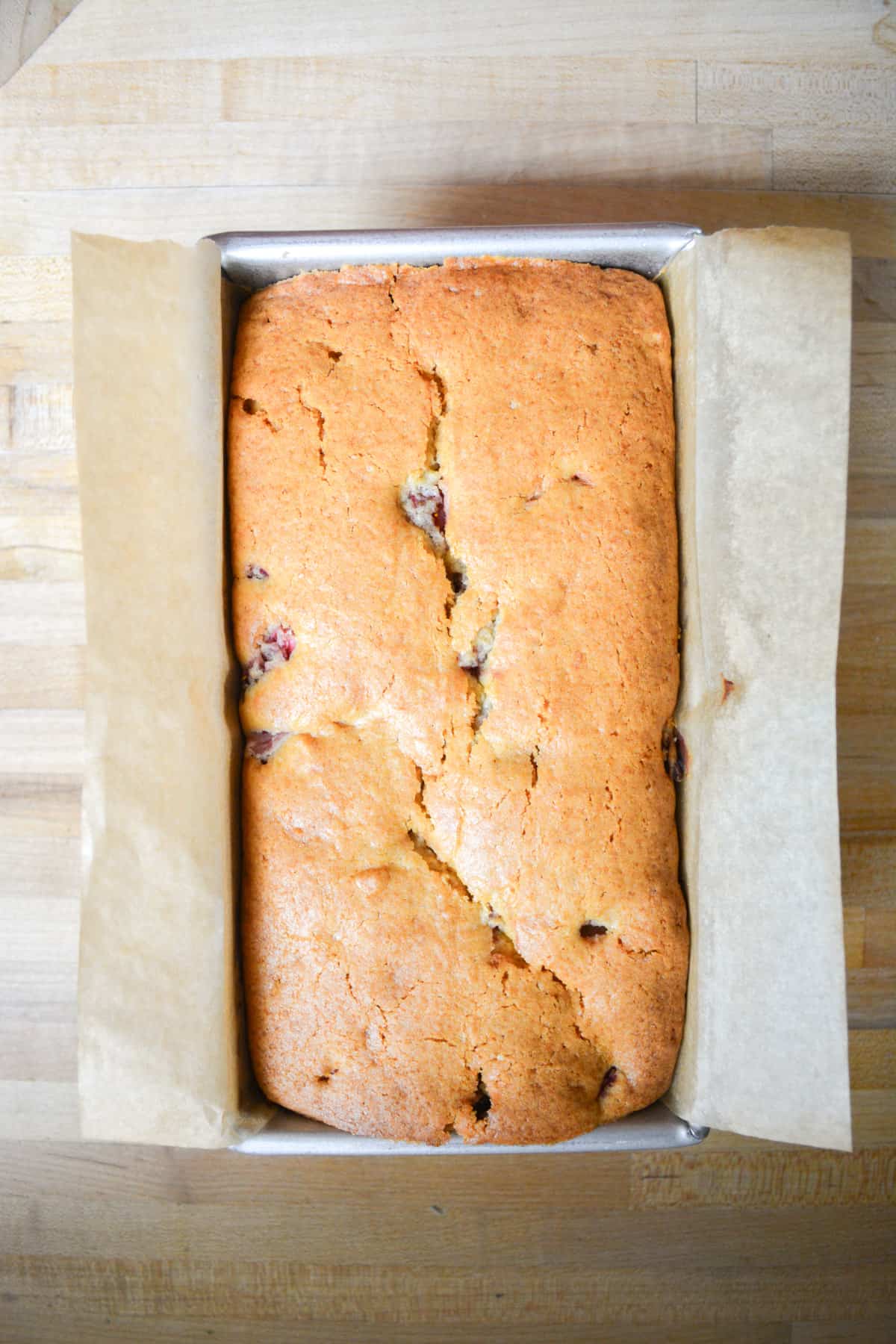 Baked strawberry pound cake in a loaf pan.