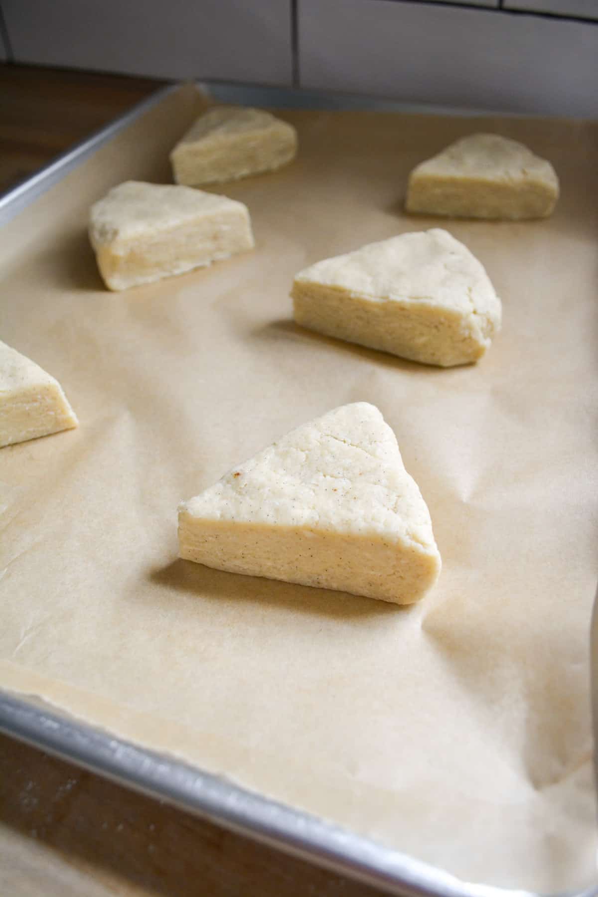 Vegan scone dough placed onto a parchment lined baking sheet.