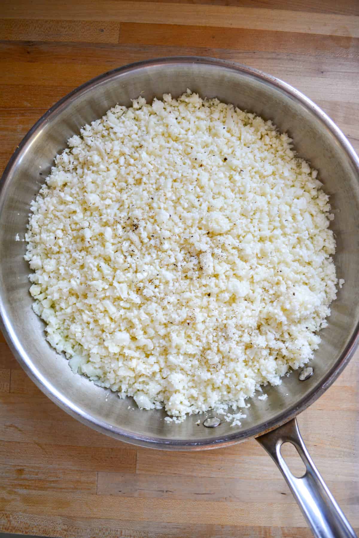 Cauliflower rice in a large skillet.