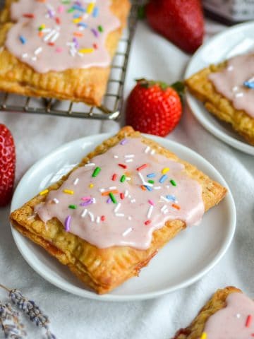 Homemade Vegan Pop Tart on a small plate with more pop tarts in the foreground and background.