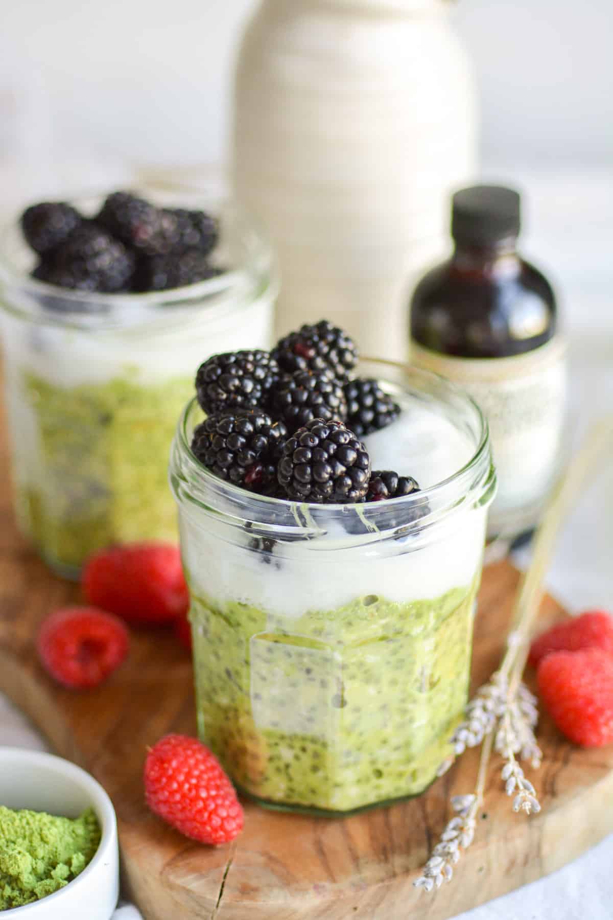 Vegan Matcha Overnight Oats in a jar topped with yogurt and blackberries.