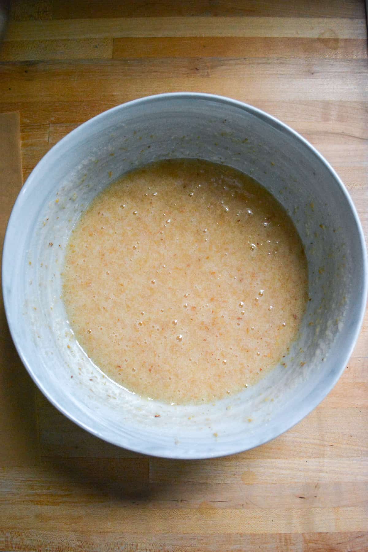 Flax egg and sugar whisked together in a mixing bowl.
