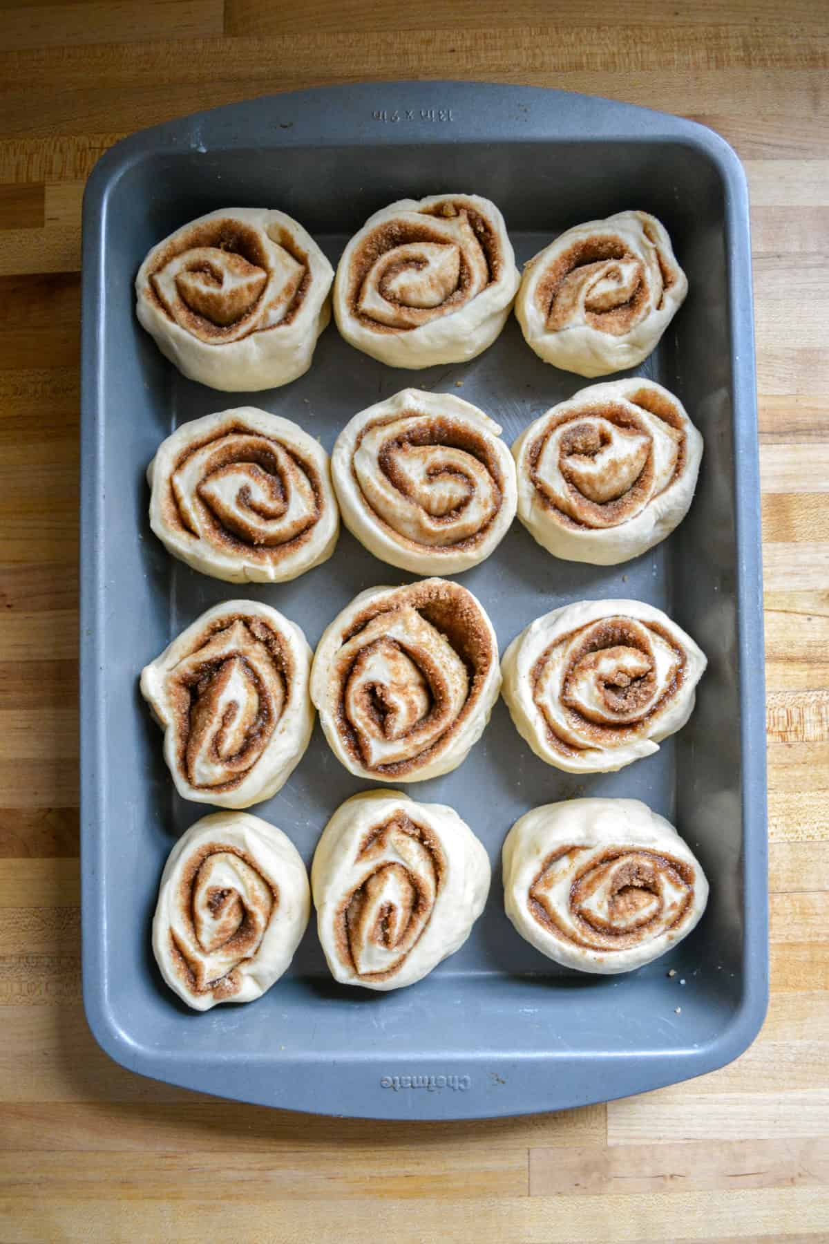 Vegan cinnamon rolls cut and placed into a baking pan.